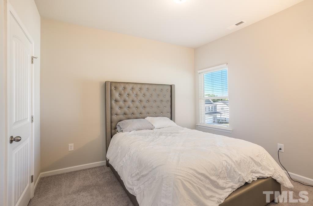 6801 Resting Grove Road Raleigh, NC 27610 - Photo 17 of 28 a bedroom with a bed and a window