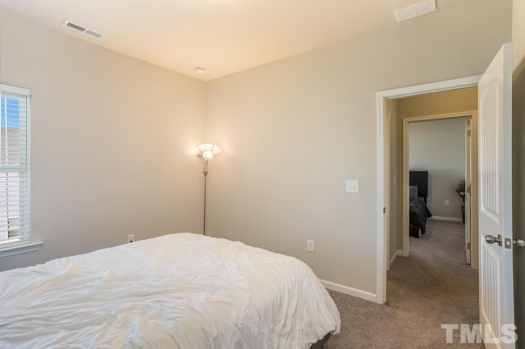 6801 Resting Grove Road Raleigh, NC 27610 - Photo 18 of 28 a bedroom with a bed and a closet