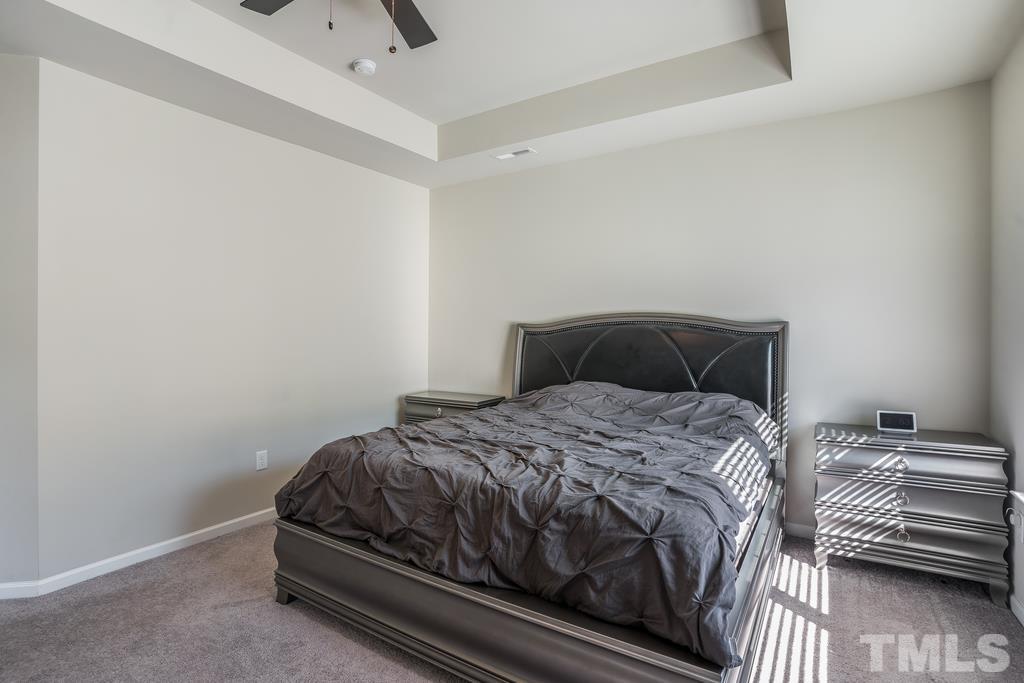 6801 Resting Grove Road Raleigh, NC 27610 - Photo 23 of 28 a bedroom with a bed and wooden floor