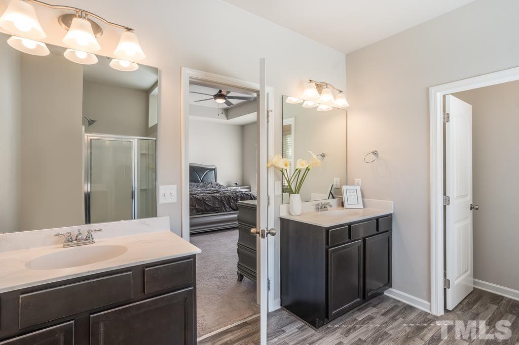 6801 Resting Grove Road Raleigh, NC 27610 - Photo 24 of 28 a bathroom with a sink double vanity and a mirror