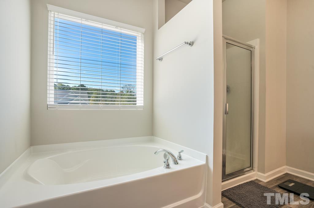 6801 Resting Grove Road Raleigh, NC 27610 - Photo 25 of 28 a white bath tub sitting next to a window