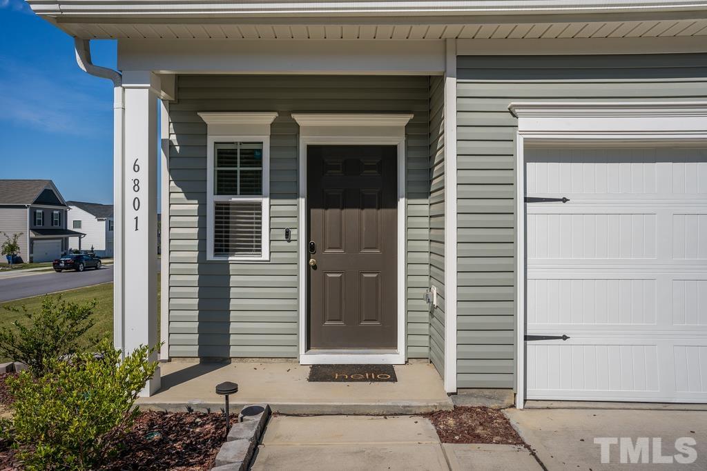 6801 Resting Grove Road Raleigh, NC 27610 - Photo 4 of 28 a potted plant in front of a door