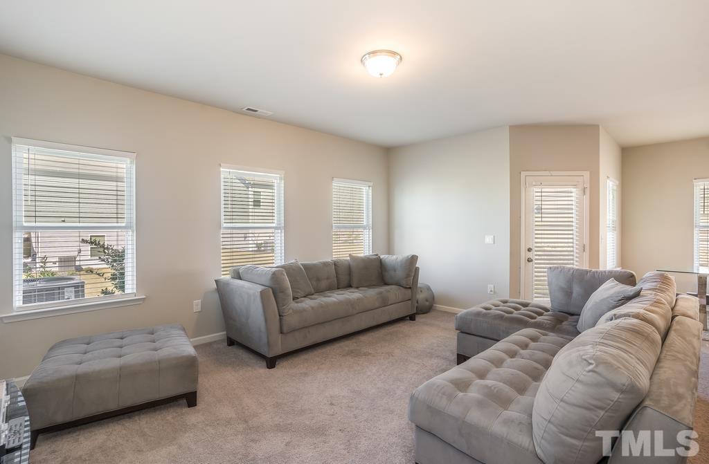 6801 Resting Grove Road Raleigh, NC 27610 - Photo 6 of 28 a living room with furniture a couch and a window