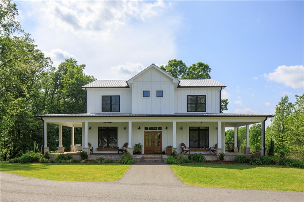 9620 Waldrip Road Gainesville, GA 30506 - Photo 1 of 1 a front view of a house with swimming pool and porch