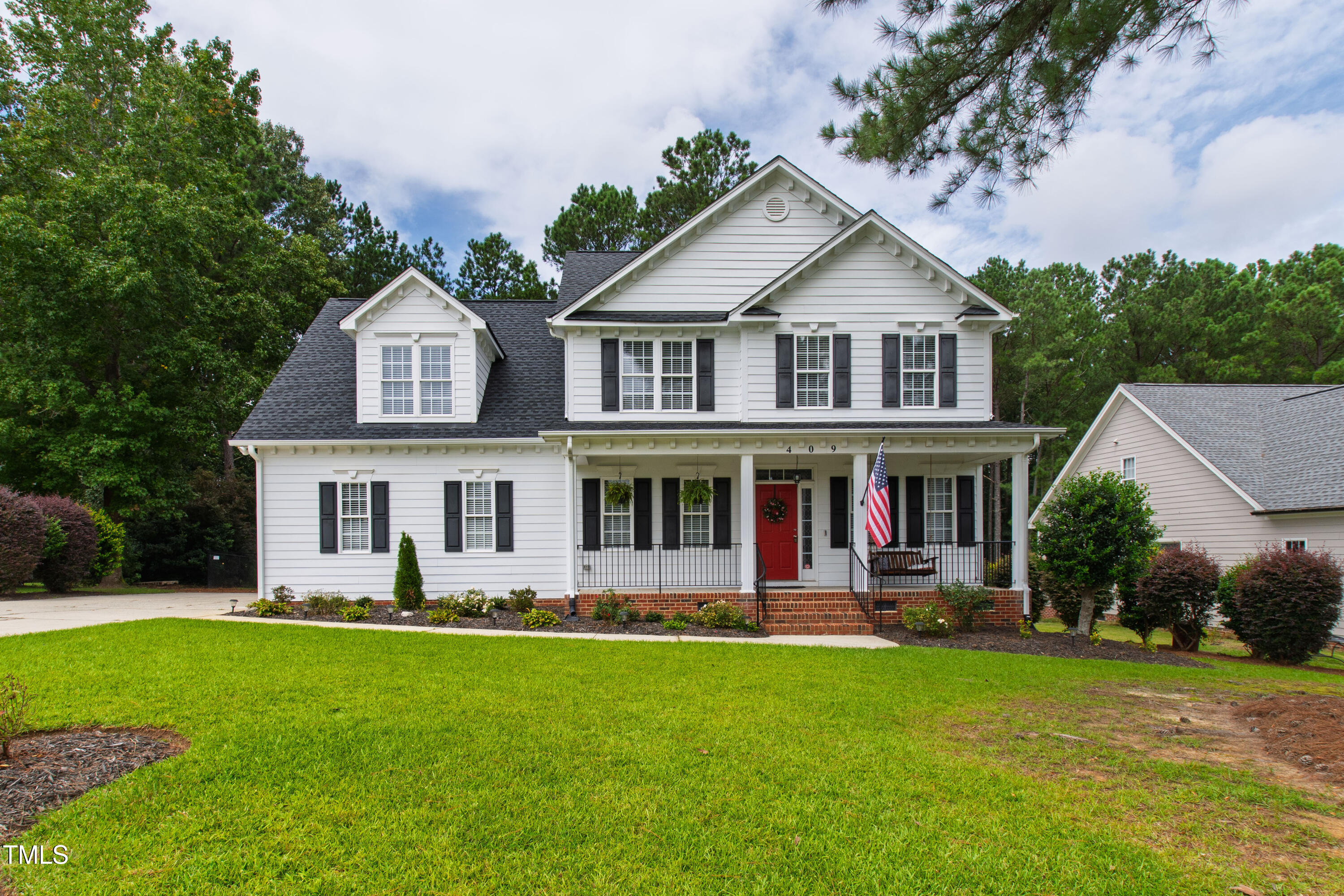 a front view of house with yard and green space