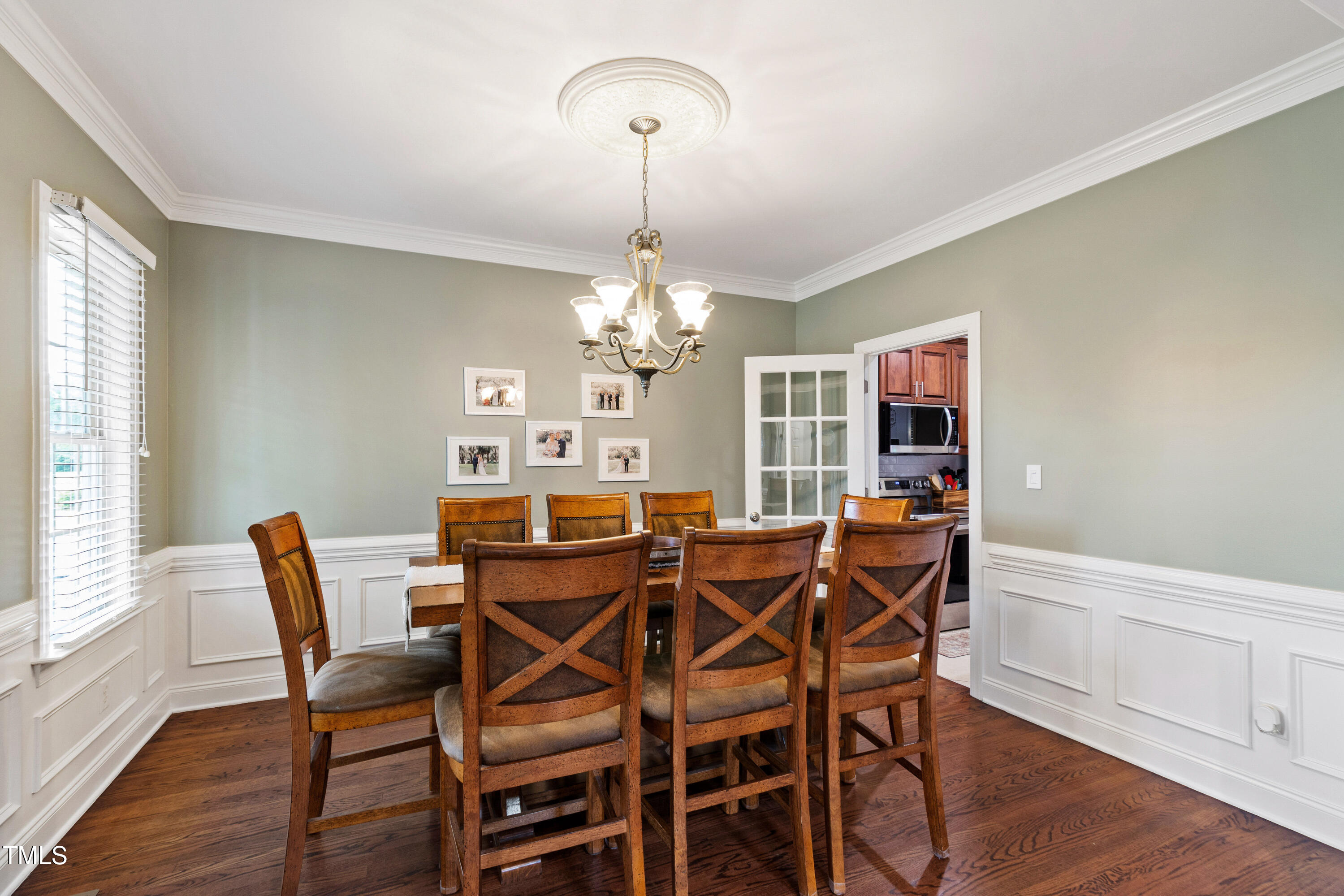 409 Broadmoor Way Clayton, NC 27520 - Photo 15 of 55 a view of a dining room with furniture a chandelier and wooden floor