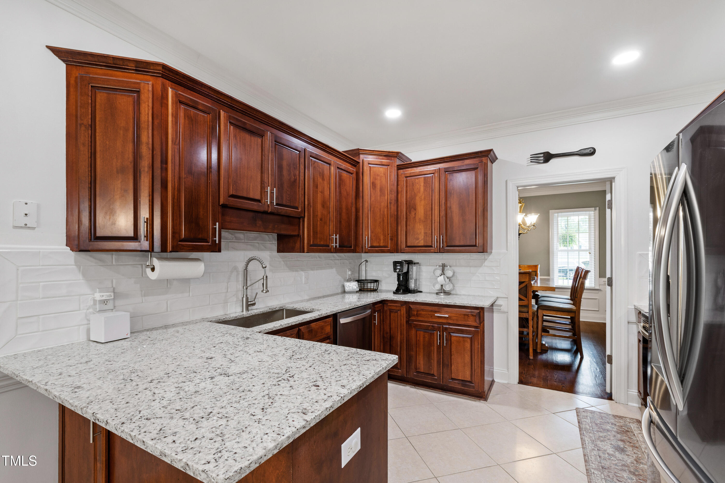 409 Broadmoor Way Clayton, NC 27520 - Photo 17 of 55 a kitchen with stainless steel appliances granite countertop wooden cabinets a sink and dishwasher