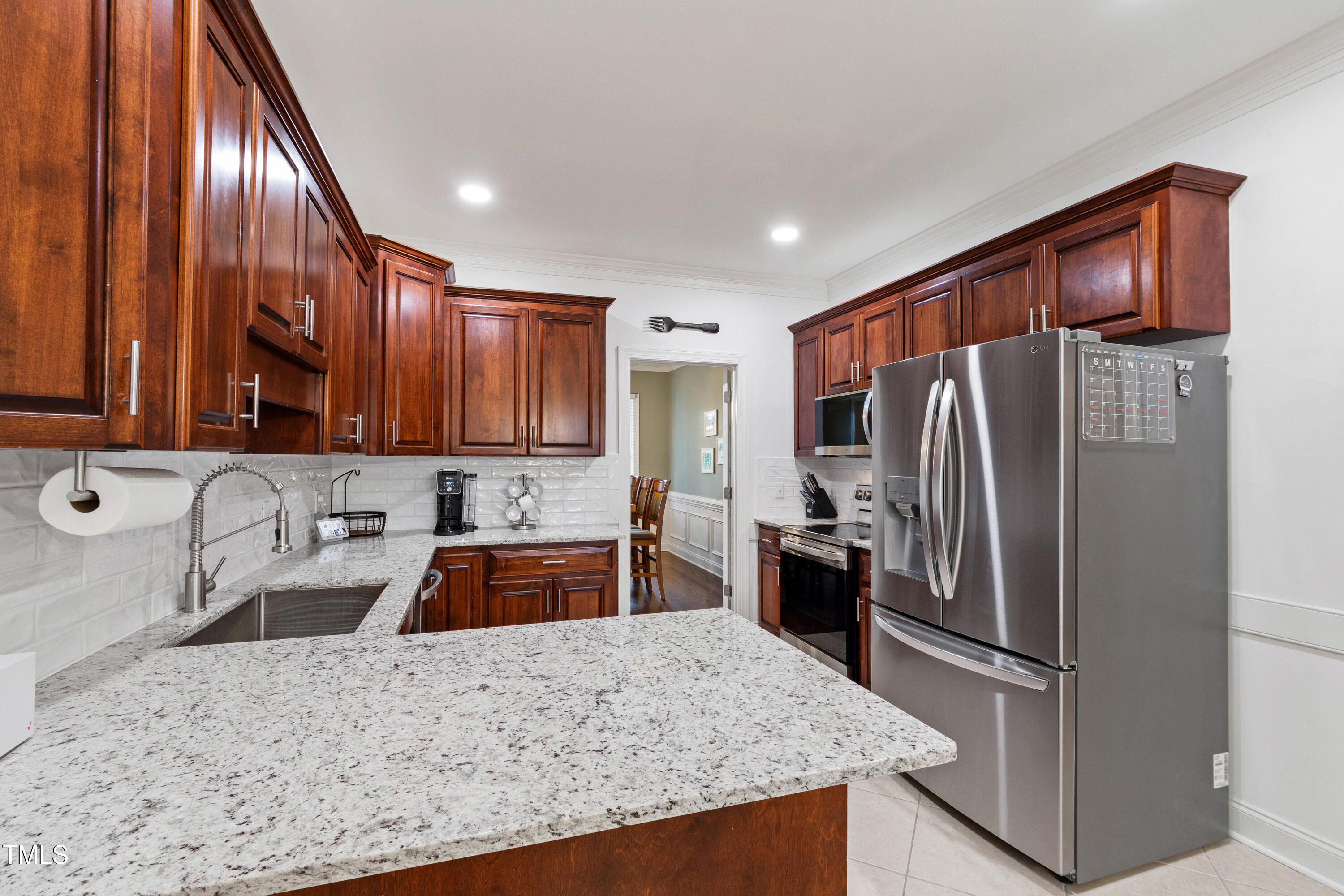 409 Broadmoor Way Clayton, NC 27520 - Photo 18 of 55 a kitchen with stainless steel appliances granite countertop a refrigerator and a sink