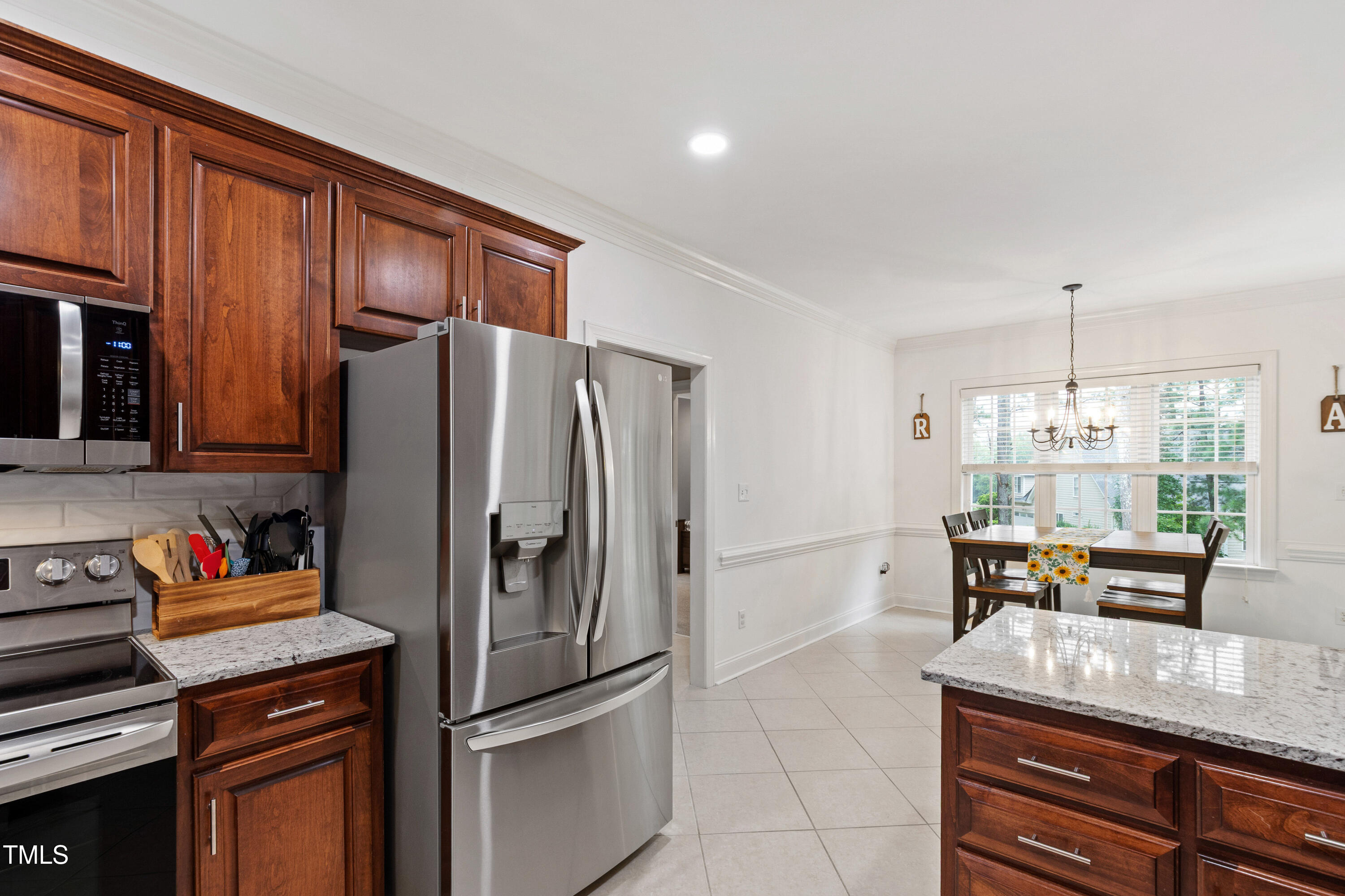 409 Broadmoor Way Clayton, NC 27520 - Photo 20 of 55 a kitchen with stainless steel appliances granite countertop a refrigerator a stove and a sink with cabinets