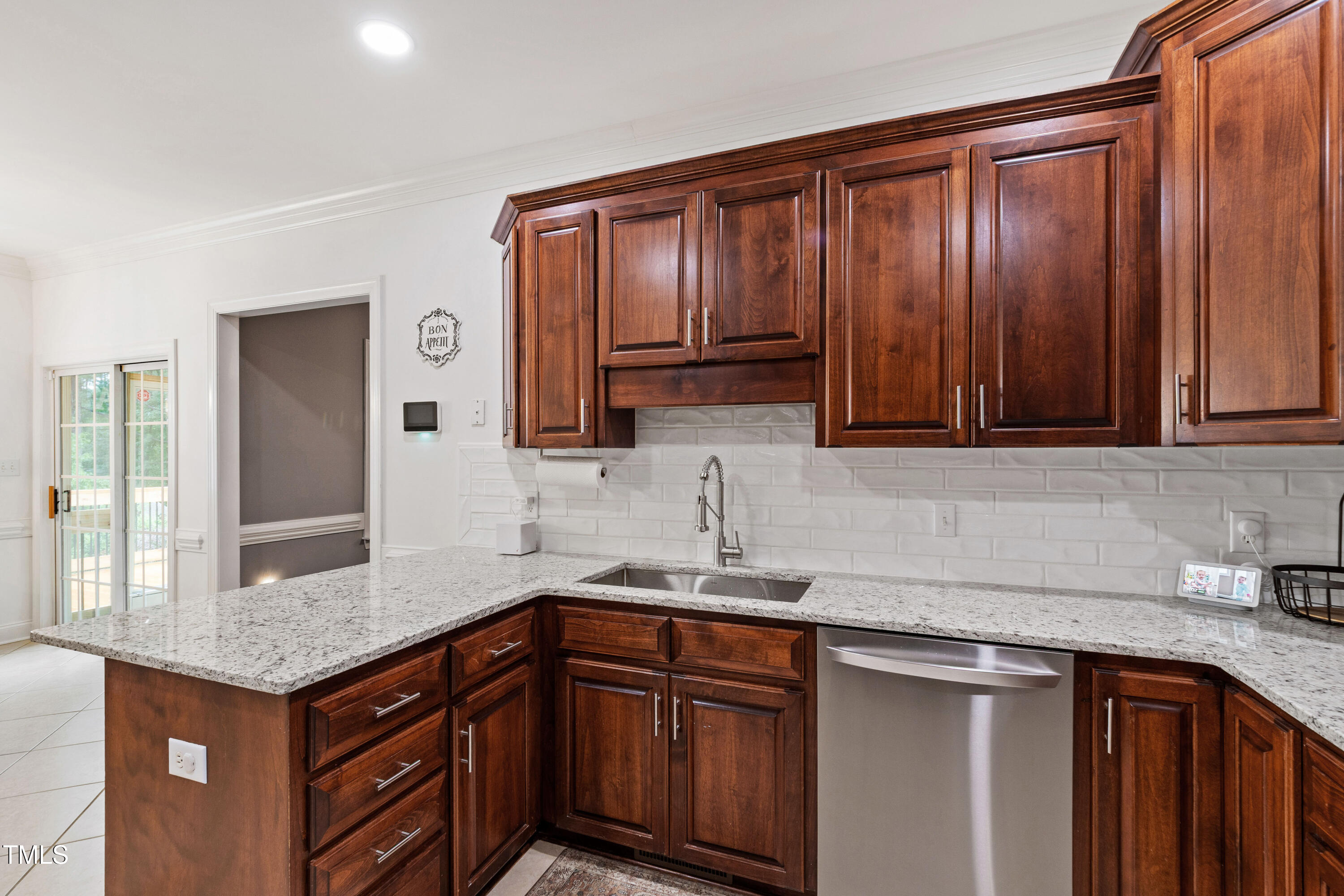 409 Broadmoor Way Clayton, NC 27520 - Photo 21 of 55 a kitchen with stainless steel appliances granite countertop wooden cabinets a sink and dishwasher