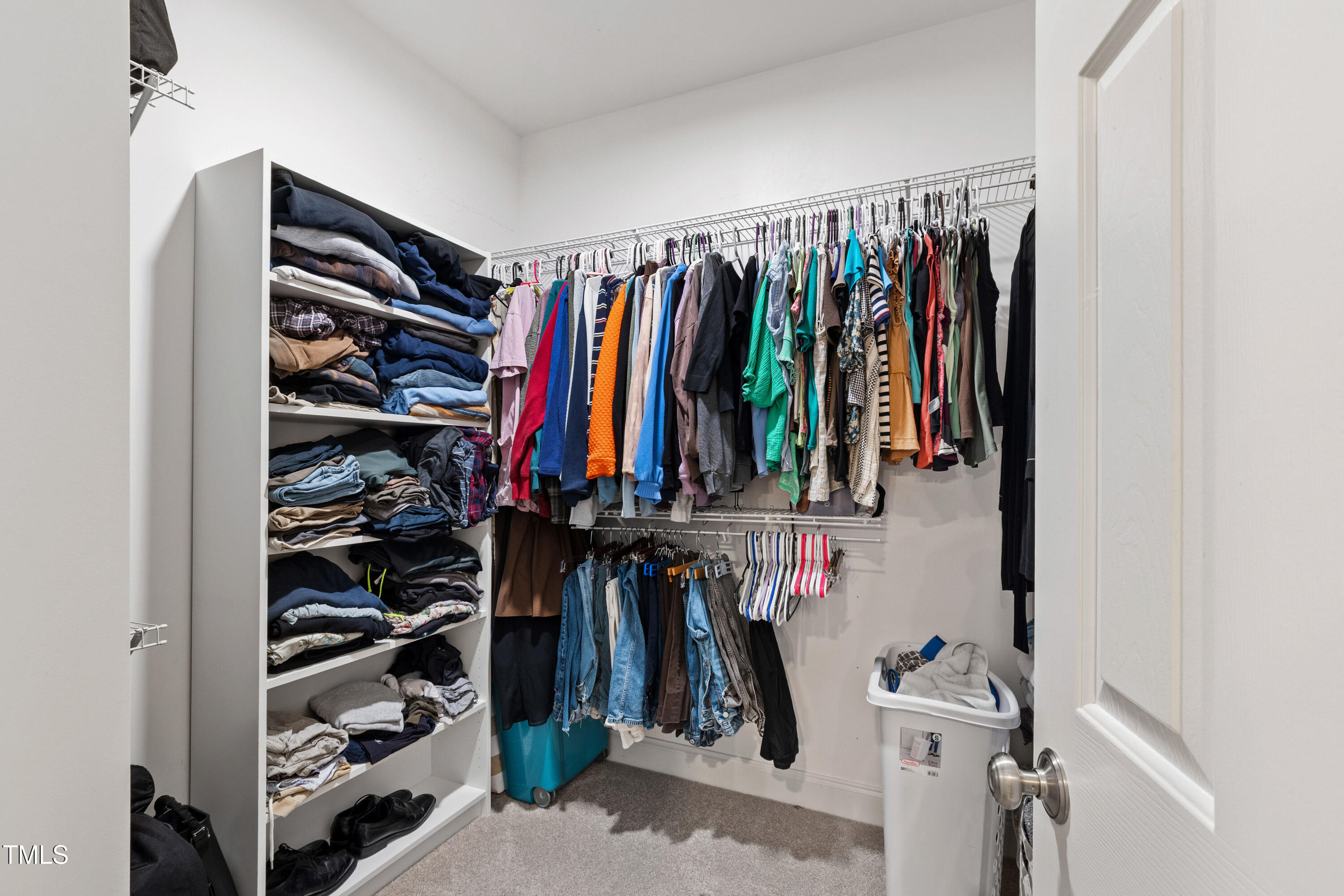 409 Broadmoor Way Clayton, NC 27520 - Photo 30 of 55 a view of walk in closet with clothes and shoes