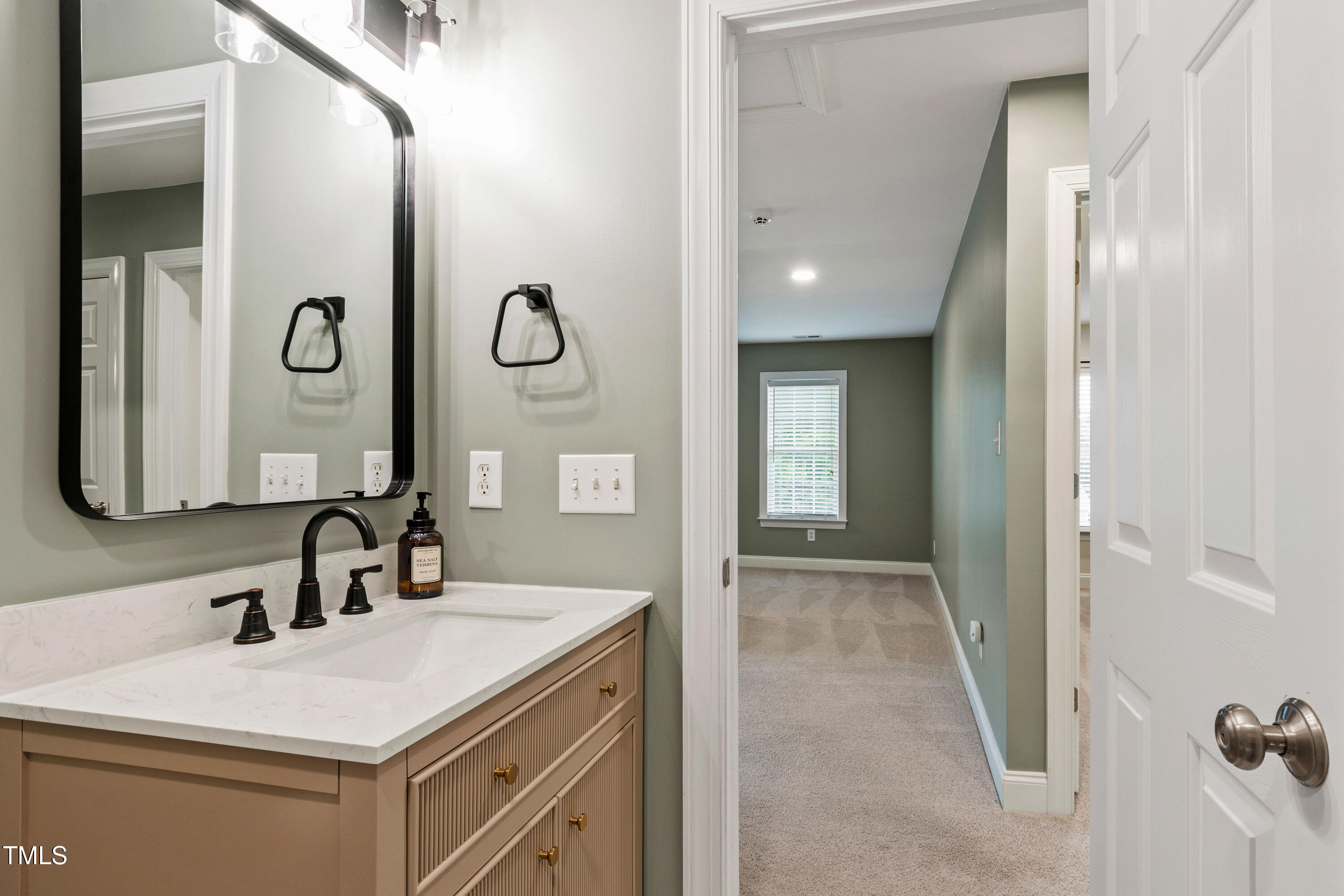 409 Broadmoor Way Clayton, NC 27520 - Photo 34 of 55 a bathroom with a sink and a mirror