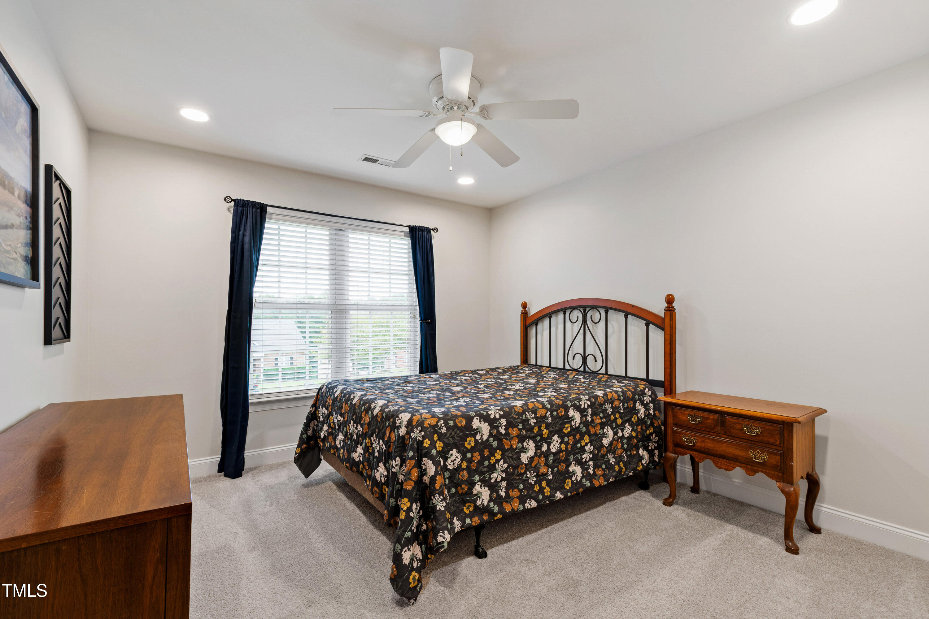 409 Broadmoor Way Clayton, NC 27520 - Photo 38 of 55 a bedroom with a bed next to a window with a projector screen