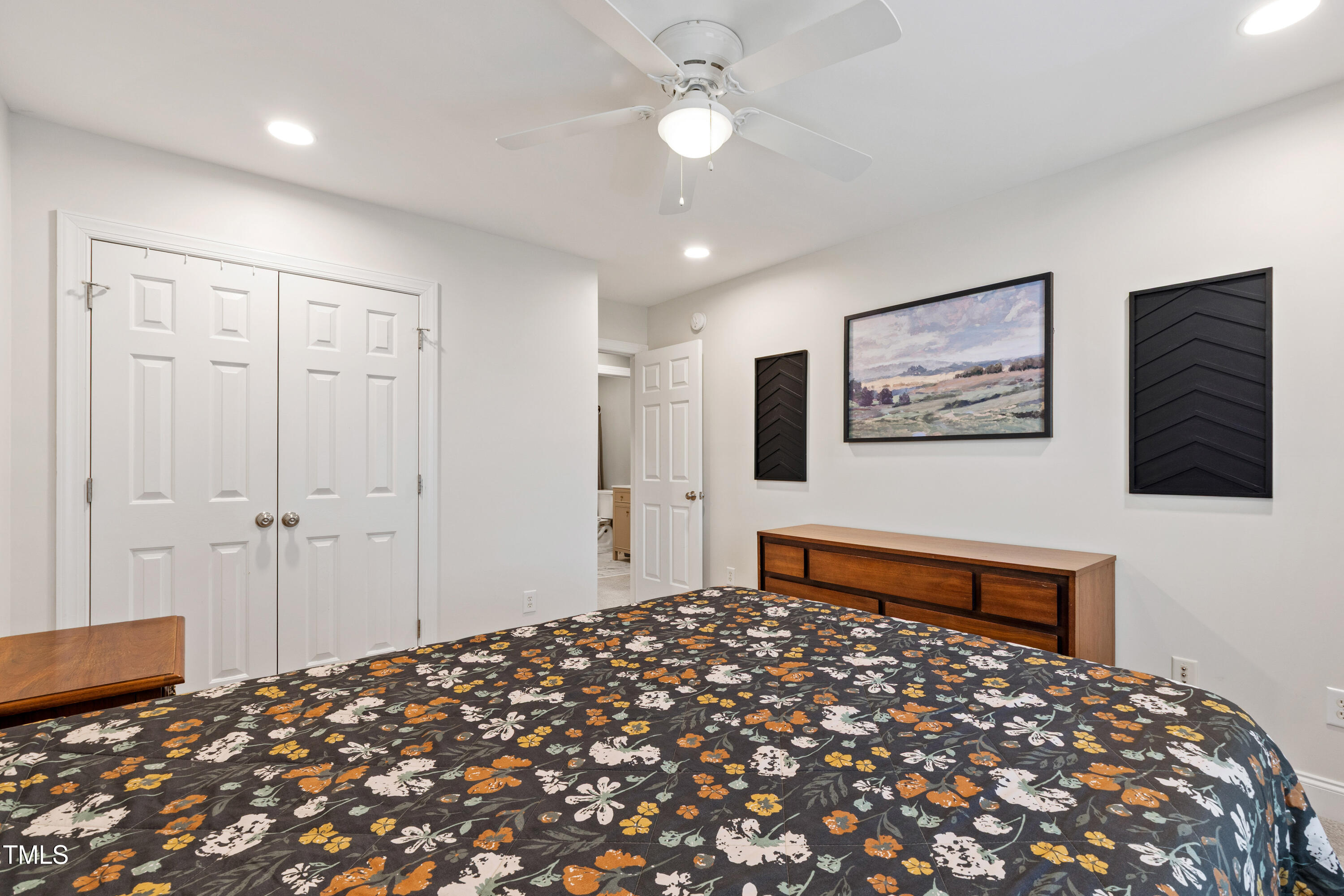 409 Broadmoor Way Clayton, NC 27520 - Photo 39 of 55 a bedroom with bed and mirror