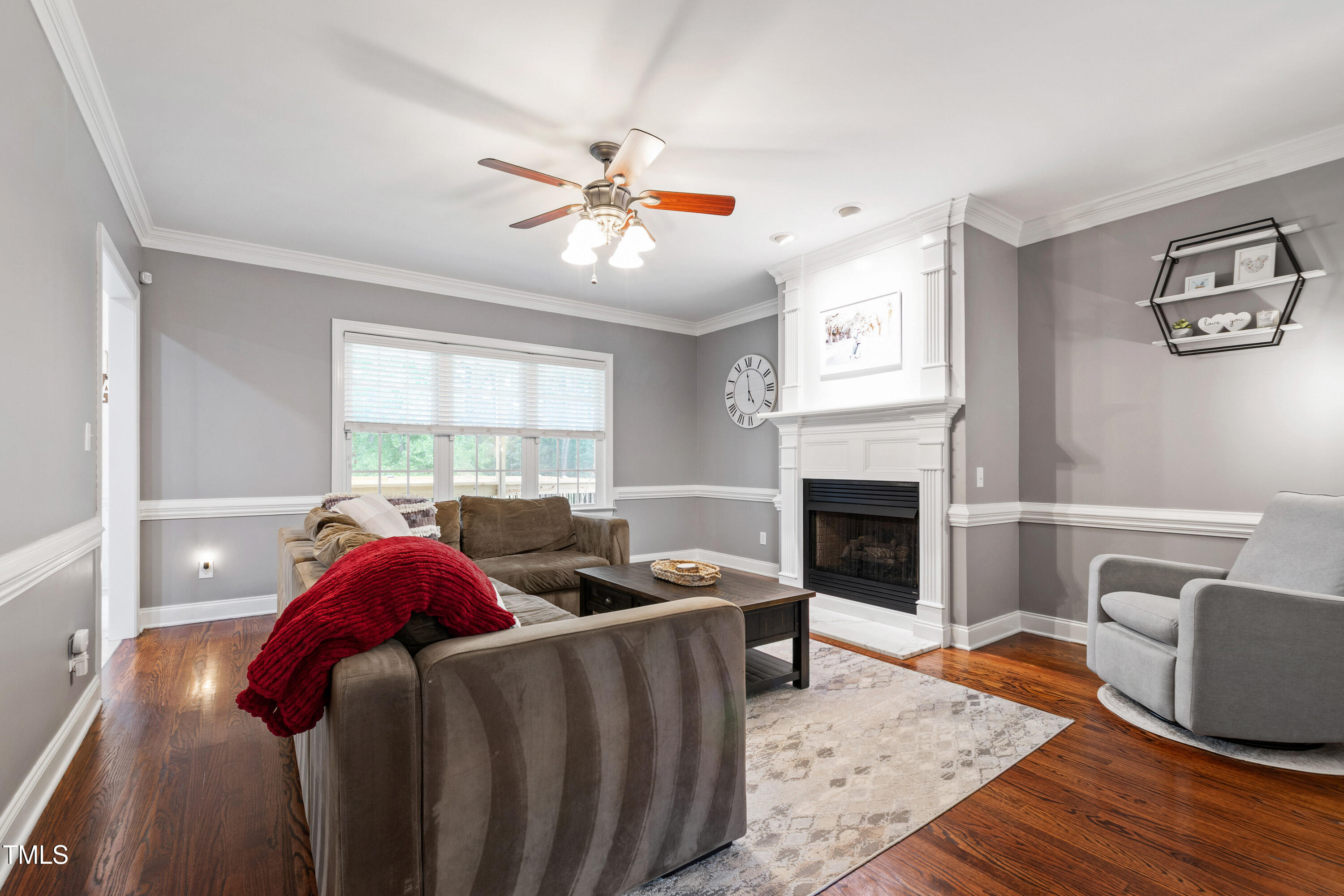 409 Broadmoor Way Clayton, NC 27520 - Photo 9 of 55 a living room with furniture a fireplace and a window