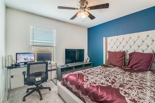 a bedroom with a large bed and a flat screen tv