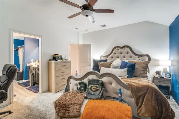 a bedroom with bed and a chandelier