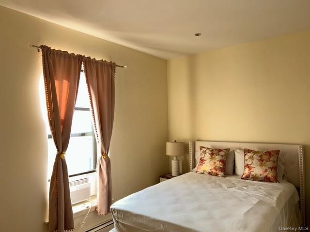 236 Utica Avenue, Unit 3F Brooklyn, NY 11213 - Photo 6 of 8 a bedroom with a large bed and a window