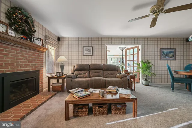 a living room with furniture a window and a fireplace