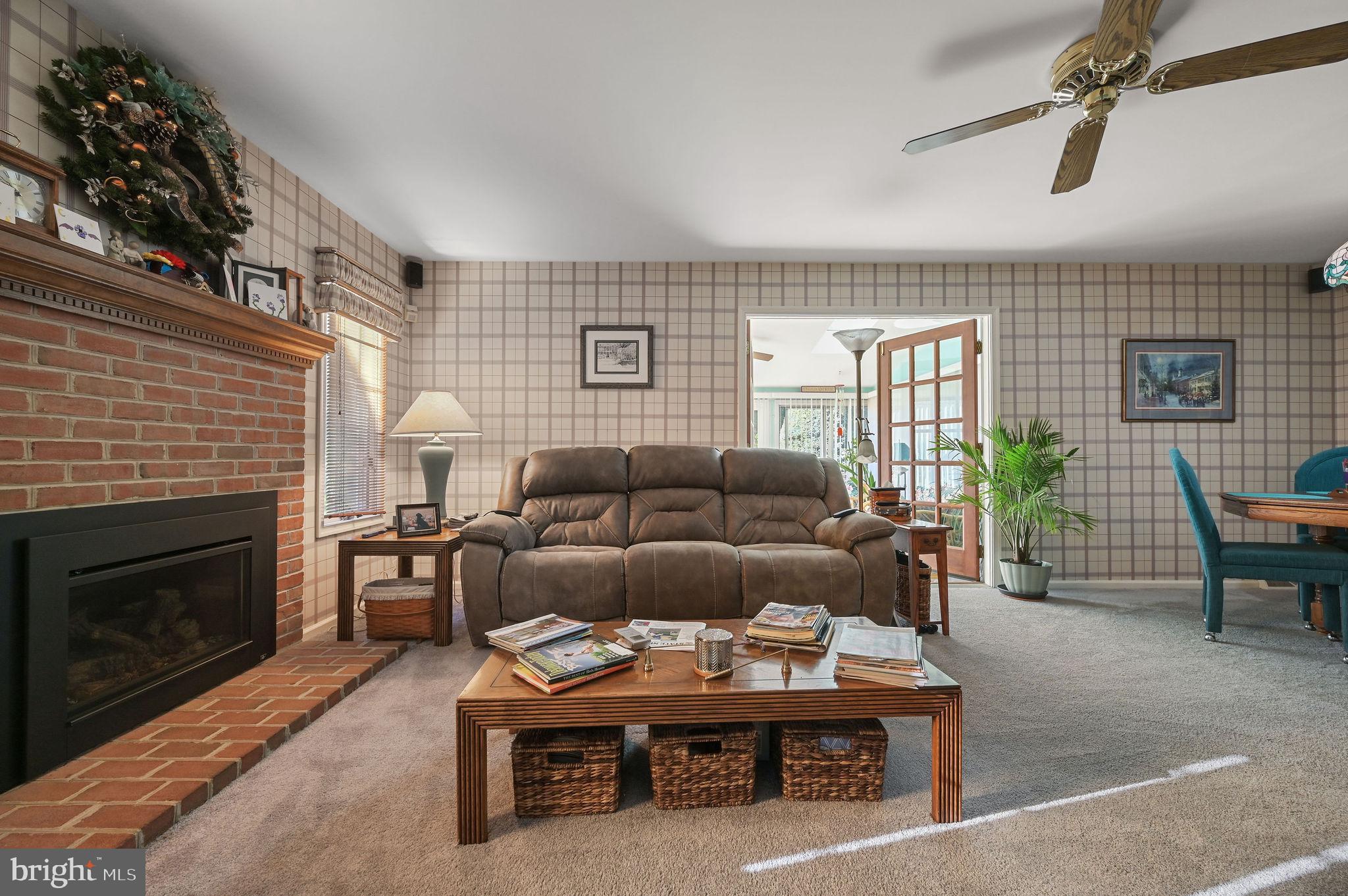 164 Burning Tree Road Dover, DE 19904 - Photo 11 of 37 a living room with furniture a window and a fireplace