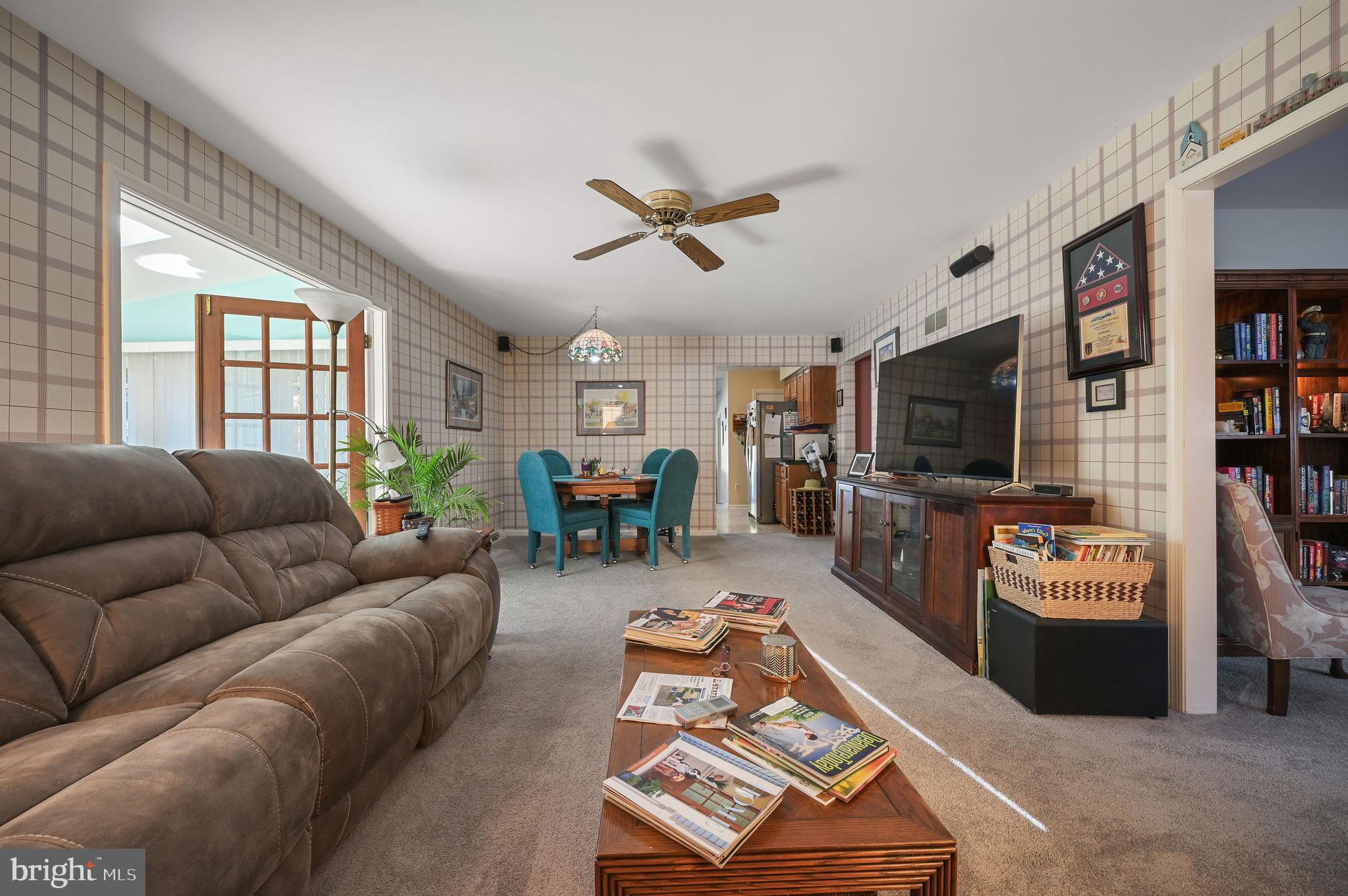 164 Burning Tree Road Dover, DE 19904 - Photo 13 of 37 a living room with furniture a flat screen tv and a window