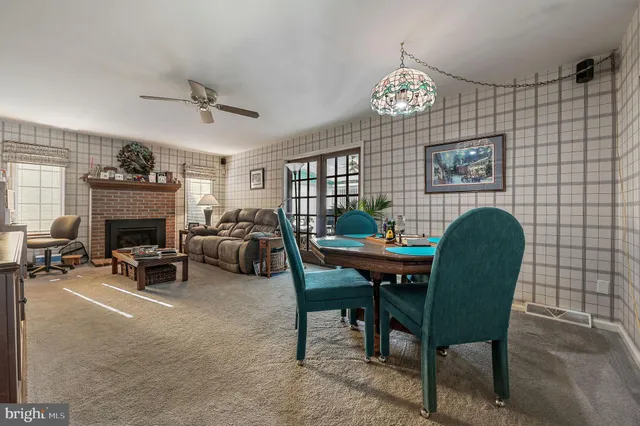 a living room with furniture a chandelier and a fireplace