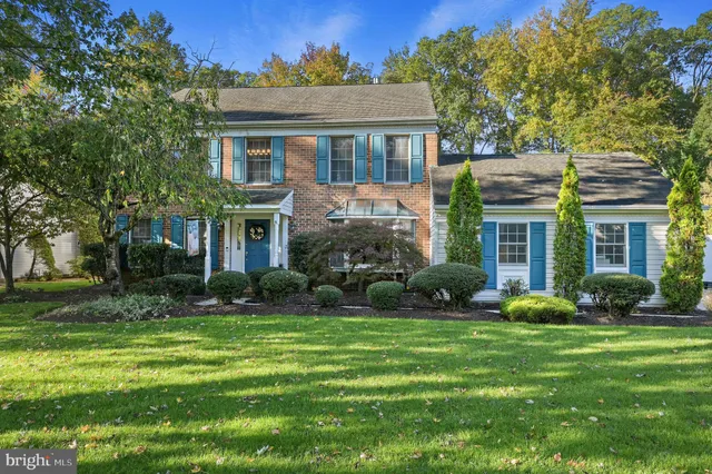 a front view of a house with garden and porch