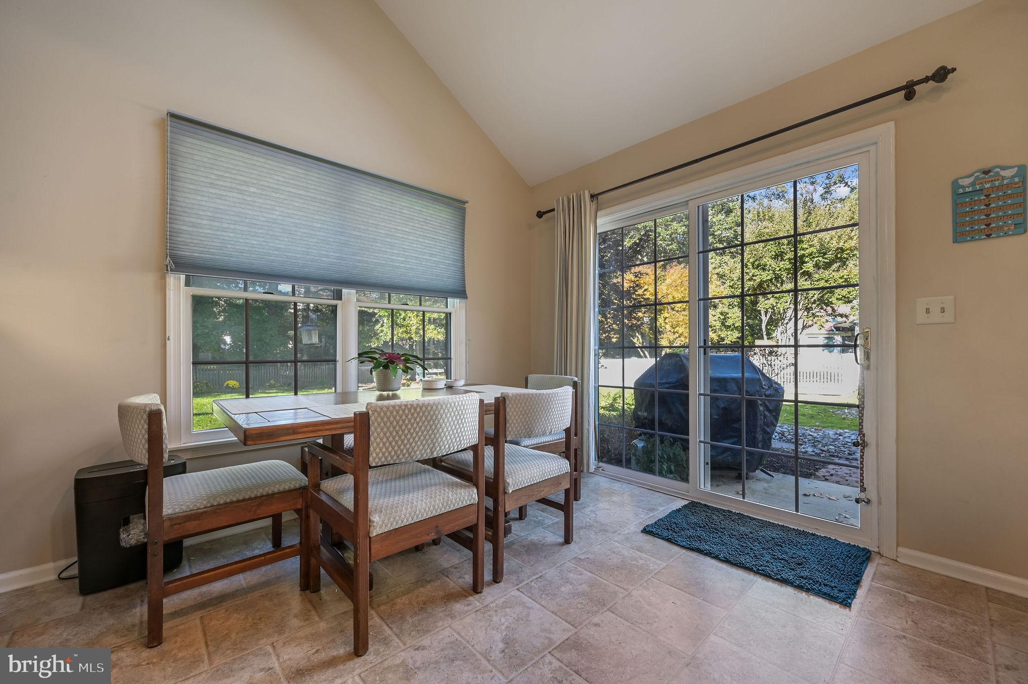 164 Burning Tree Road Dover, DE 19904 - Photo 26 of 37 a living room with furniture and a floor to ceiling window