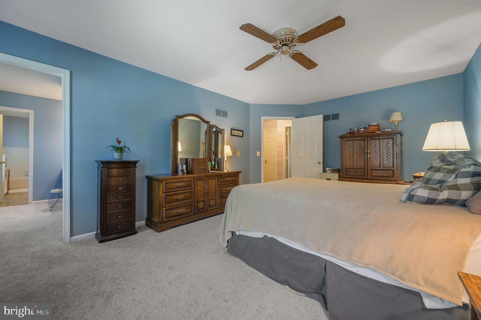 164 Burning Tree Road Dover, DE 19904 - Photo 28 of 37 a bedroom with a bed and a chandelier