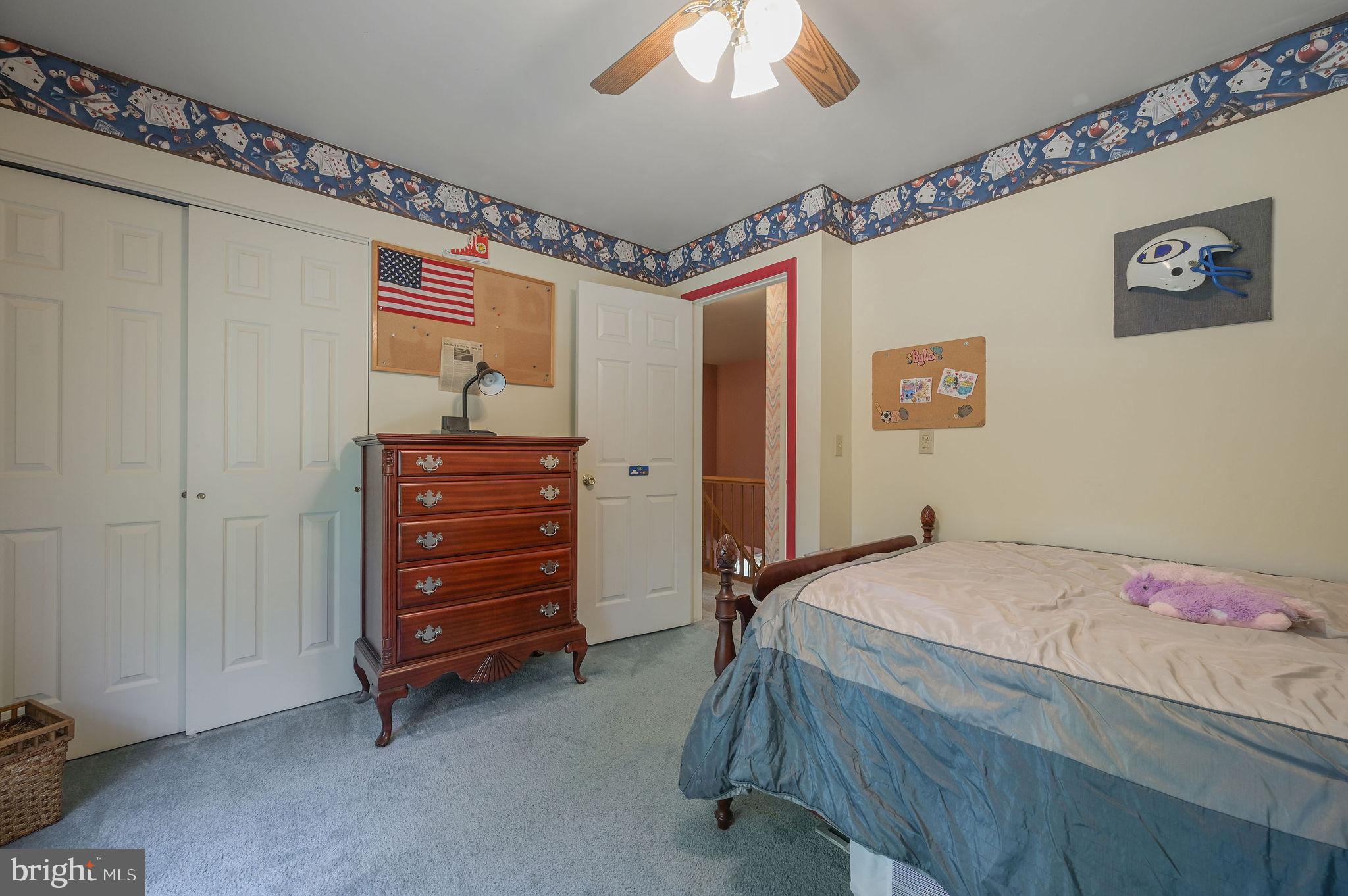 164 Burning Tree Road Dover, DE 19904 - Photo 34 of 37 a bedroom with a bed and a chandelier