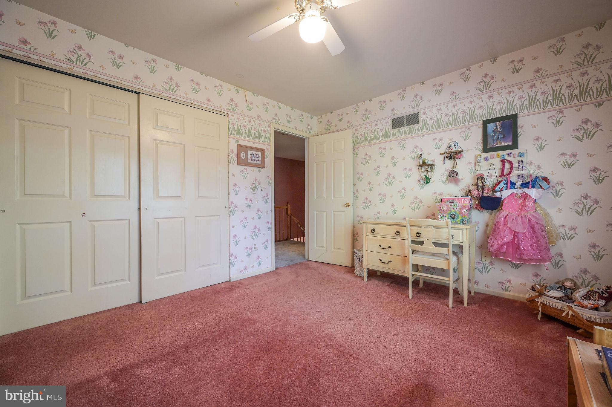164 Burning Tree Road Dover, DE 19904 - Photo 36 of 37 a bedroom with a bed and a chandelier