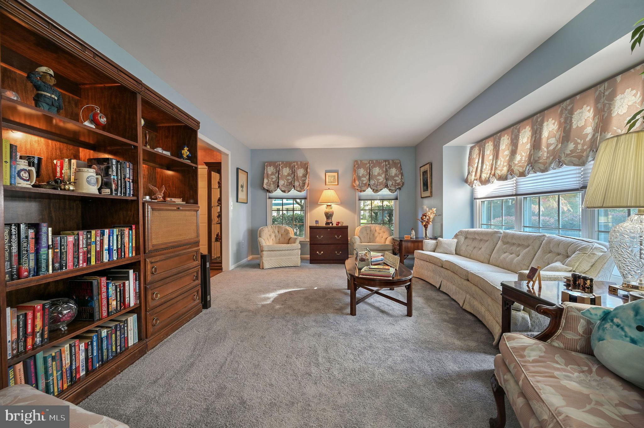 164 Burning Tree Road Dover, DE 19904 - Photo 10 of 37 a living room with furniture and a book shelf