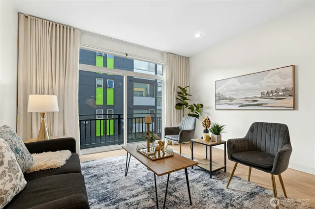 a living room with furniture and a potted plant
