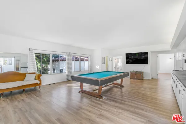 a view of a livingroom with furniture and floor to ceiling window