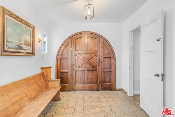 a room with furniture pool table flat screen tv and windows
