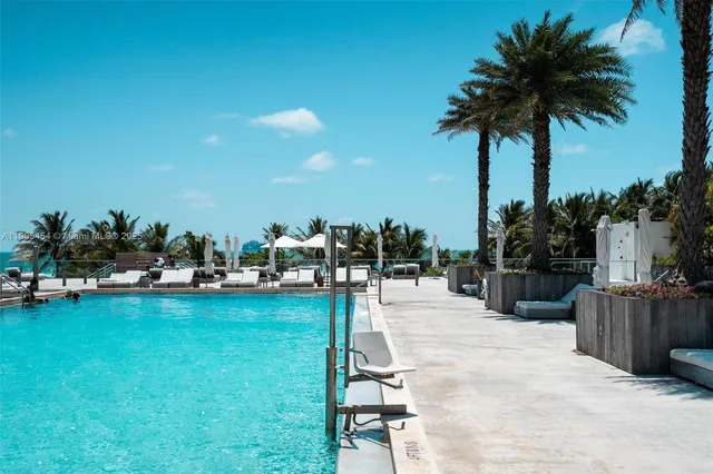 a roof deck with table and chairs and potted plants