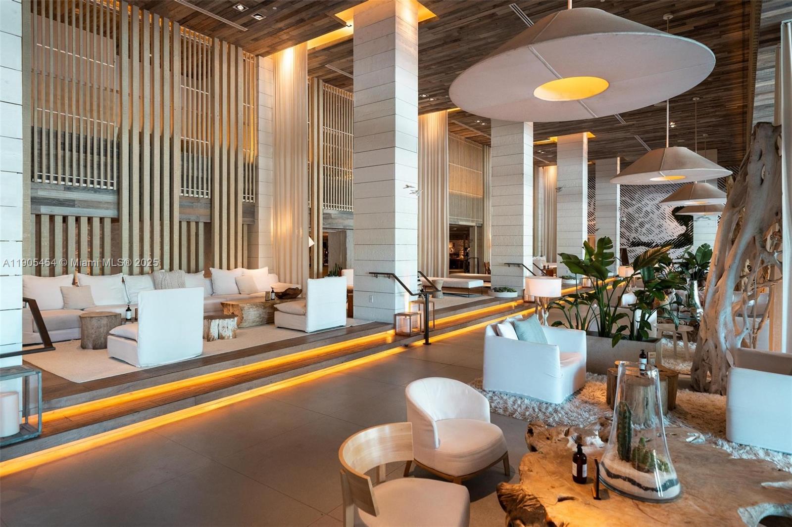 2301 Collins Avenue, Unit 1414/1415 Miami Beach, FL 33139 - Photo 39 of 40 a lobby with furniture and floor to ceiling windows