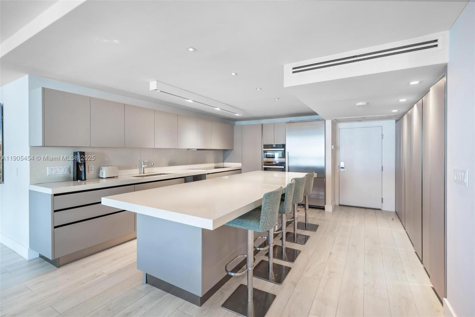 2301 Collins Avenue, Unit 1414/1415 Miami Beach, FL 33139 - Photo 7 of 40 a kitchen with a sink a counter top space stainless steel appliances and cabinets