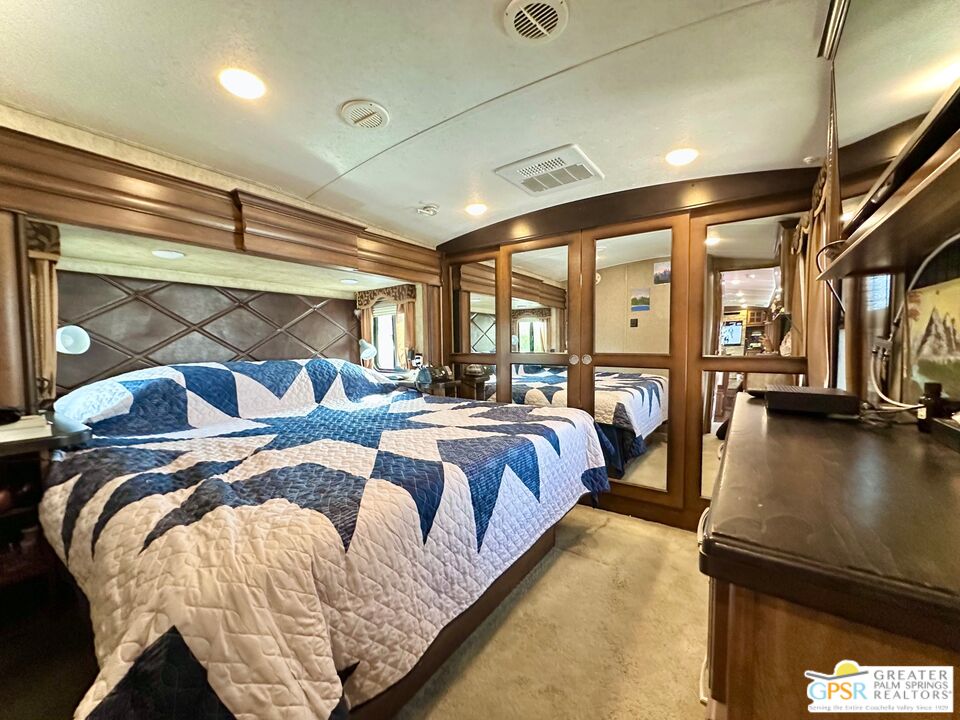 69801 Ramon Road, Unit 266 Cathedral City, CA 92234 - Photo 12 of 23 a bed room with a bed and a night stand