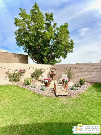 a backyard of a house with table and chairs