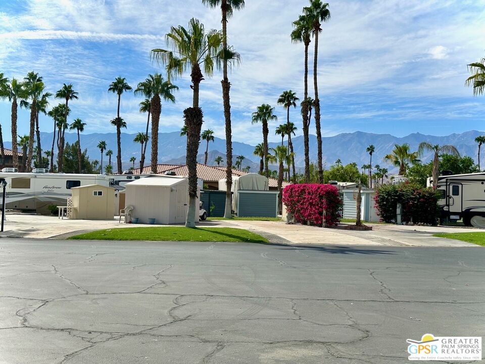 69801 Ramon Road, Unit 266 Cathedral City, CA 92234 - Photo 23 of 23 a white house with a yard and palm trees