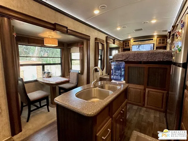 a kitchen with sink and chairs