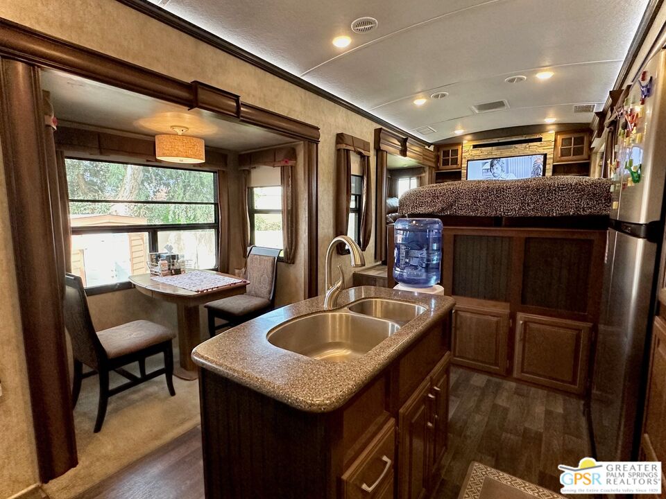 69801 Ramon Road, Unit 266 Cathedral City, CA 92234 - Photo 6 of 23 a kitchen with sink and chairs