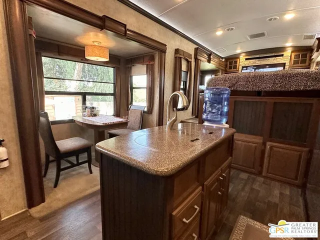 a kitchen with stainless steel appliances granite countertop a refrigerator and a stove
