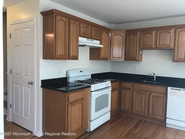 a kitchen with stainless steel appliances granite countertop a sink stove and cabinets