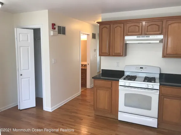 a kitchen with a stove top oven and cabinets
