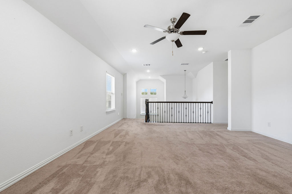1005 Ridge Runner Drive Georgetown, TX 78628 - Photo 20 of 32 Spacious carpeted room featuring a ceiling fan with integrated lighting, recessed lighting, and a window with blinds