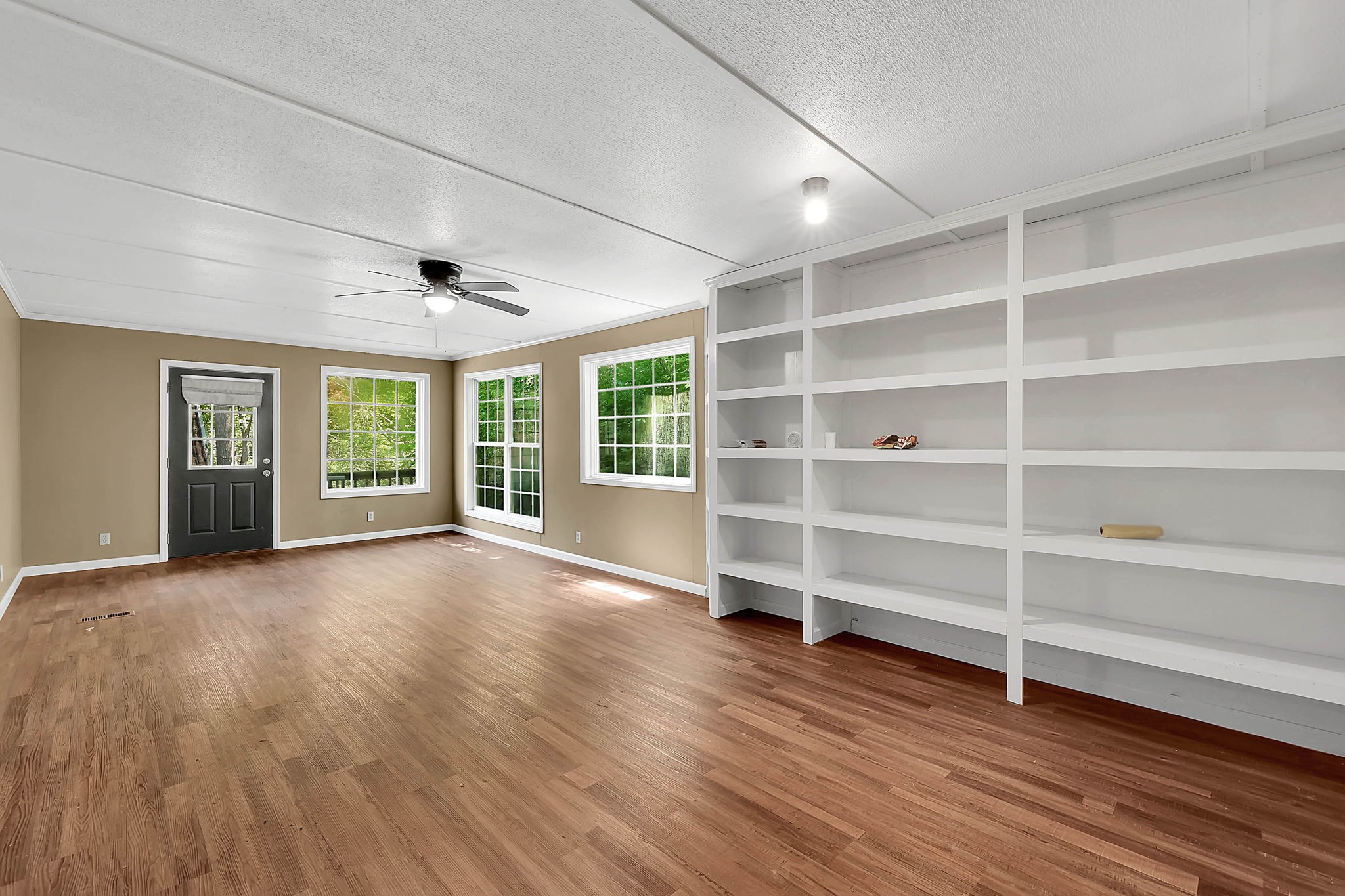 660 Rogues Fork Road Bethpage, TN 37022 - Photo 12 of 55 a view of an empty room with a window and wooden floor
