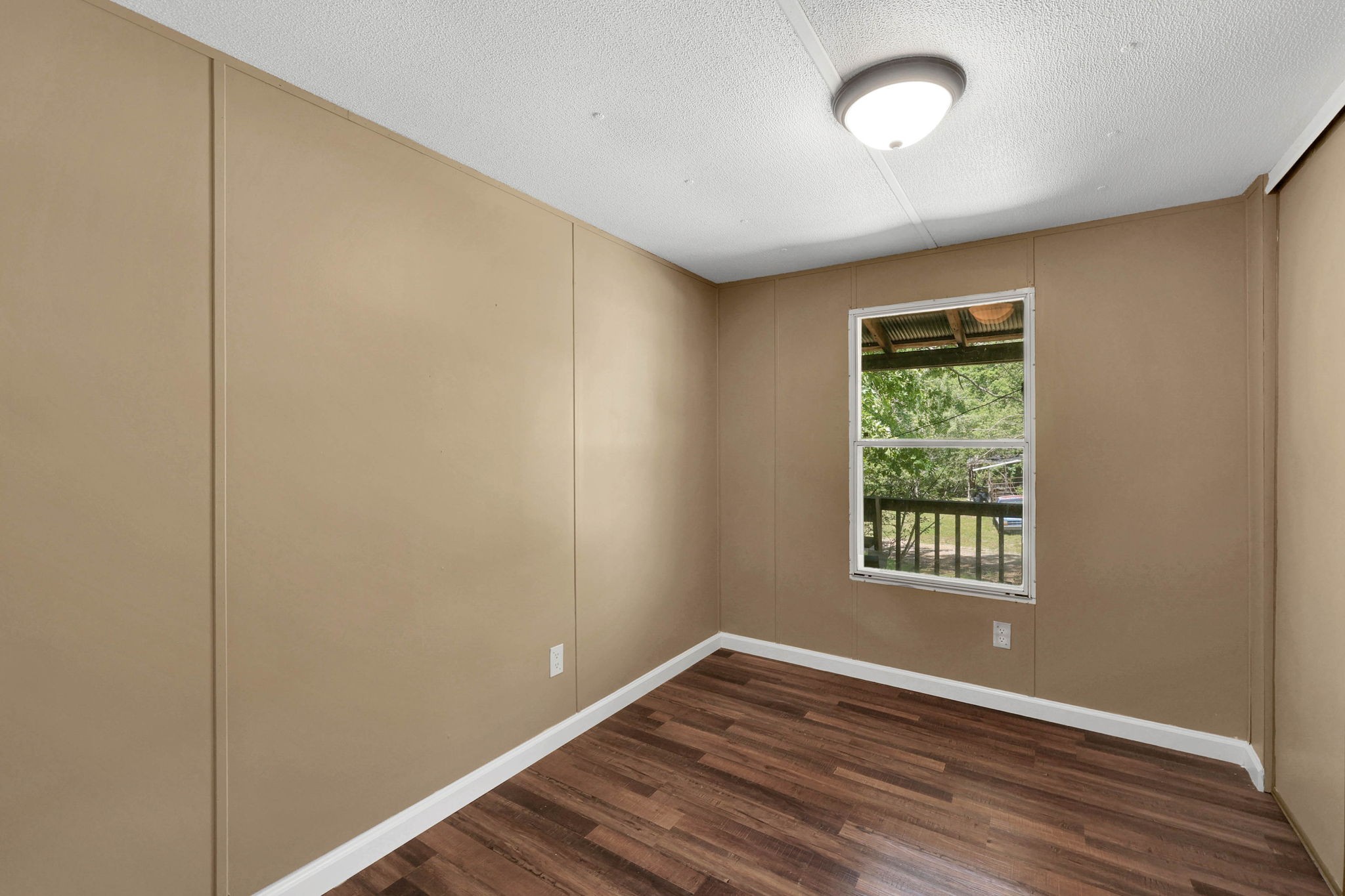 660 Rogues Fork Road Bethpage, TN 37022 - Photo 13 of 55 an empty room with wooden floor and windows