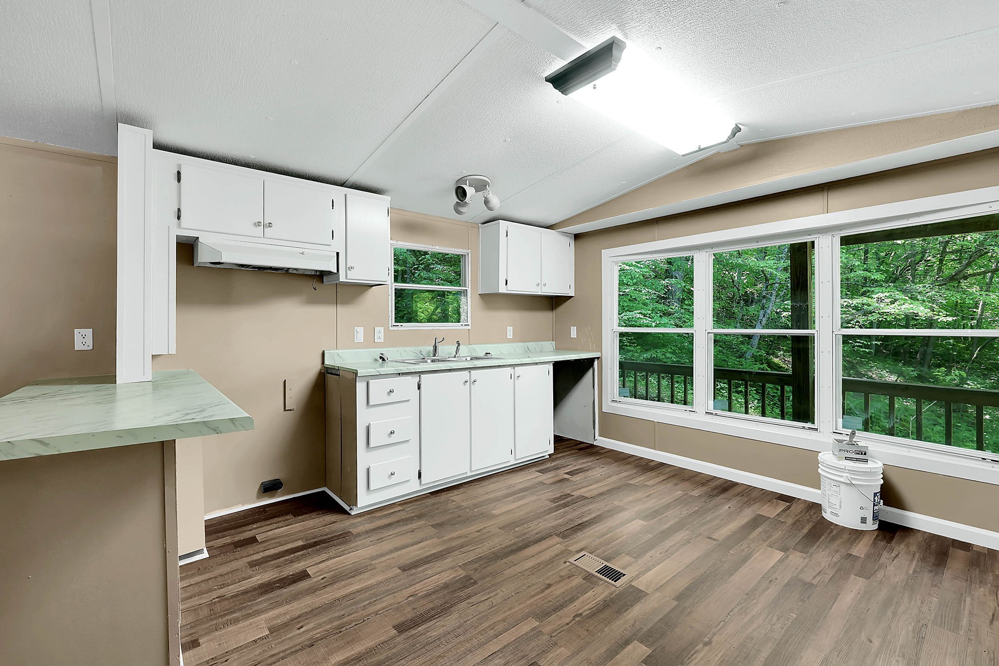 660 Rogues Fork Road Bethpage, TN 37022 - Photo 17 of 55 a kitchen with stainless steel appliances a stove top oven a sink and white cabinets with wooden floor